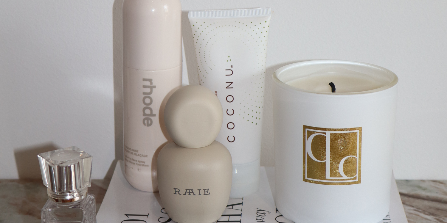 Coconu body oil beside skincare products in a morning routine setting, representing organic body care as a daily wellness ritual