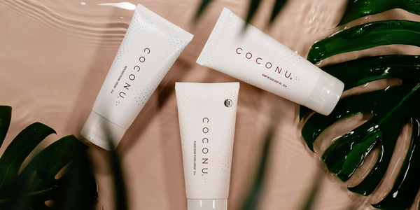 Assortment of clean personal care products on a minimal surface, representing how to evaluate natural lubricant options