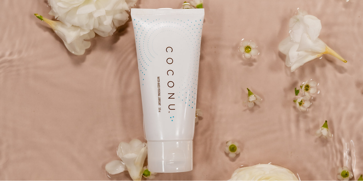 Clean personal care products arranged on a minimal surface, representing pH balance and intimate wellness