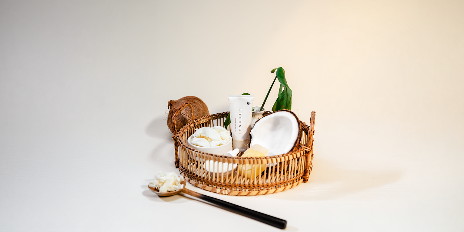 Coconu oil-based lubricant tube on a clean neutral surface, representing edible and certified organic intimate care