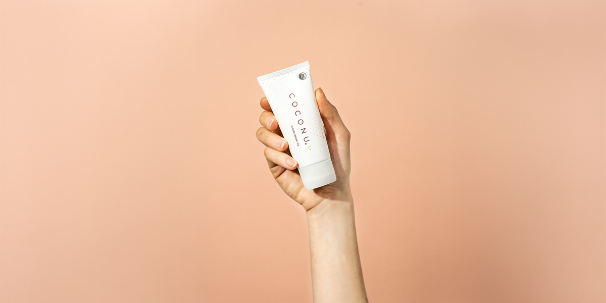 Coconu oil-based lubricant on a clean neutral surface, representing a straightforward guide to using personal lubricant