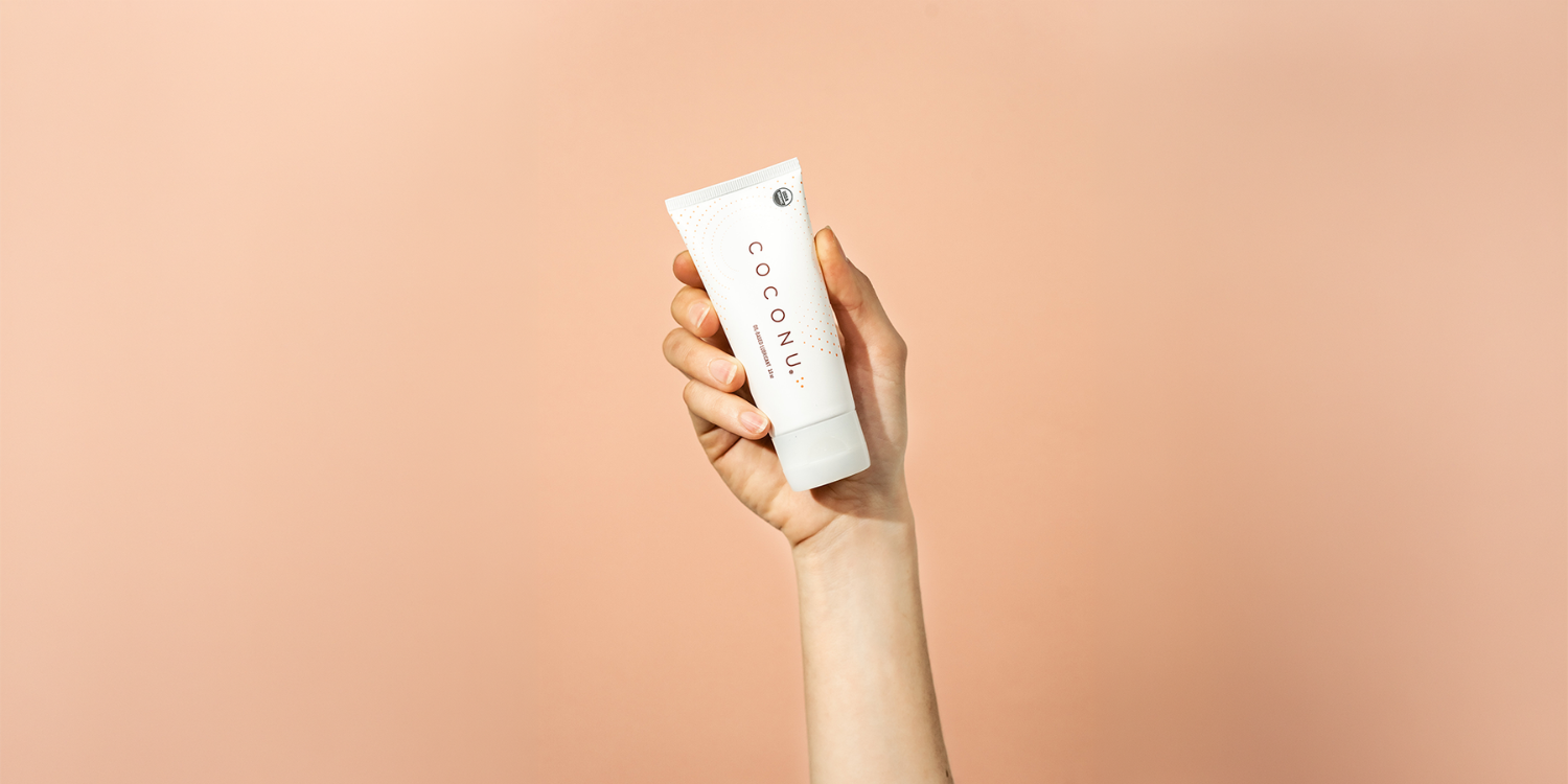 Coconu oil-based lubricant on a clean neutral surface, representing a straightforward guide to using personal lubricant