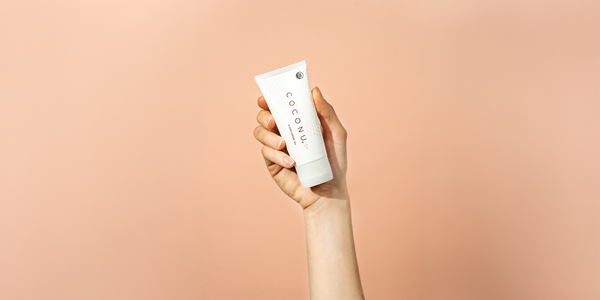 Coconu oil-based lubricant on a clean neutral surface, representing a straightforward guide to using personal lubricant