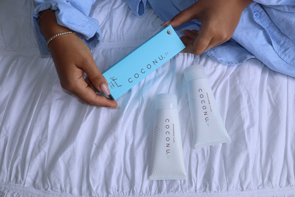 Gentle, clean personal care products on a soft neutral surface, representing safe intimate care during pregnancy