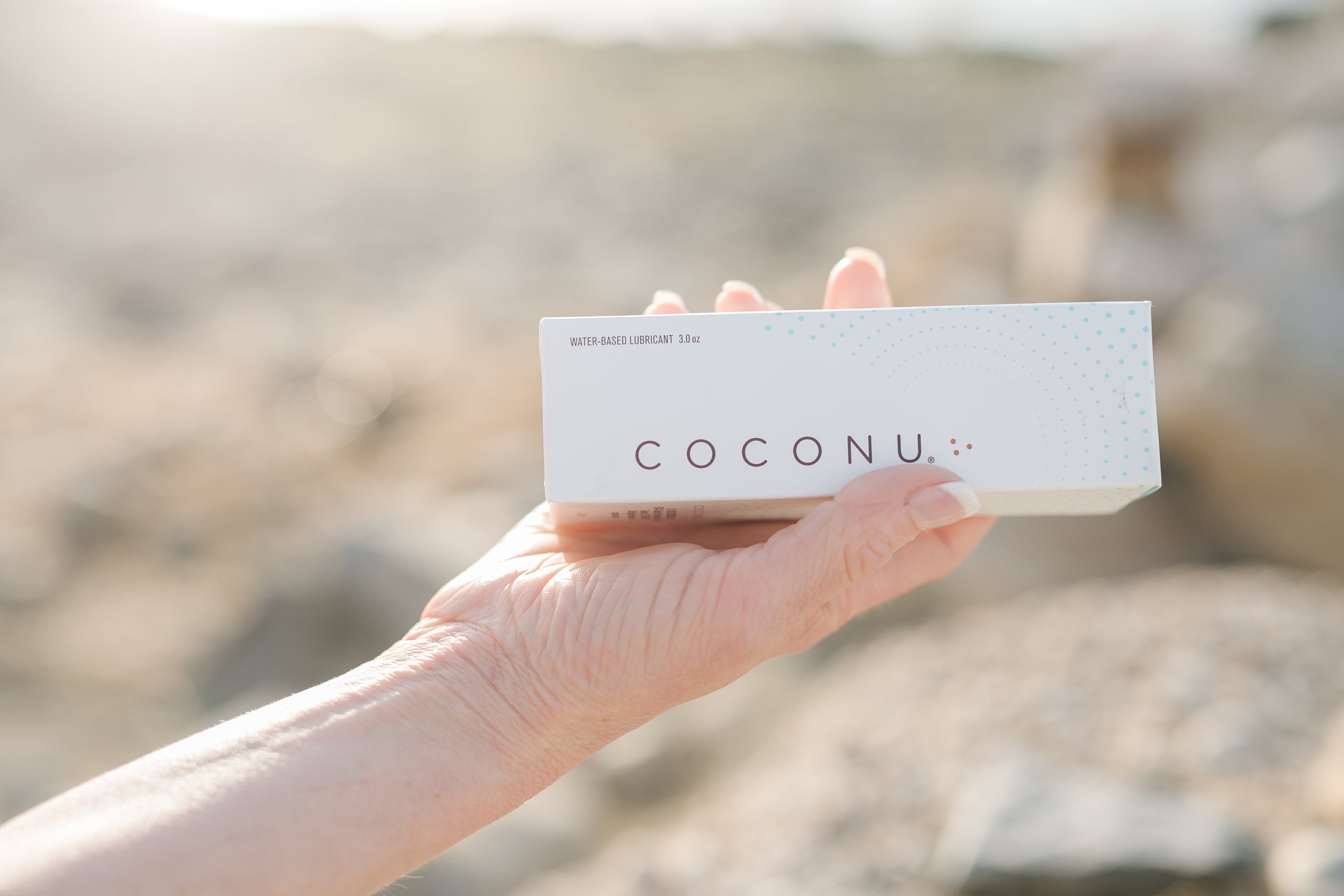 Coconu water-based lubricant tube on a clean surface, representing a latex-safe and condom-compatible lubricant