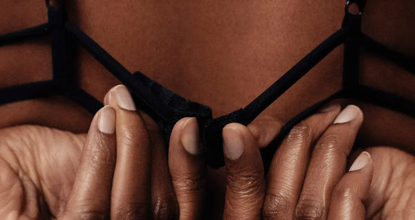 A woman unhooking her bra