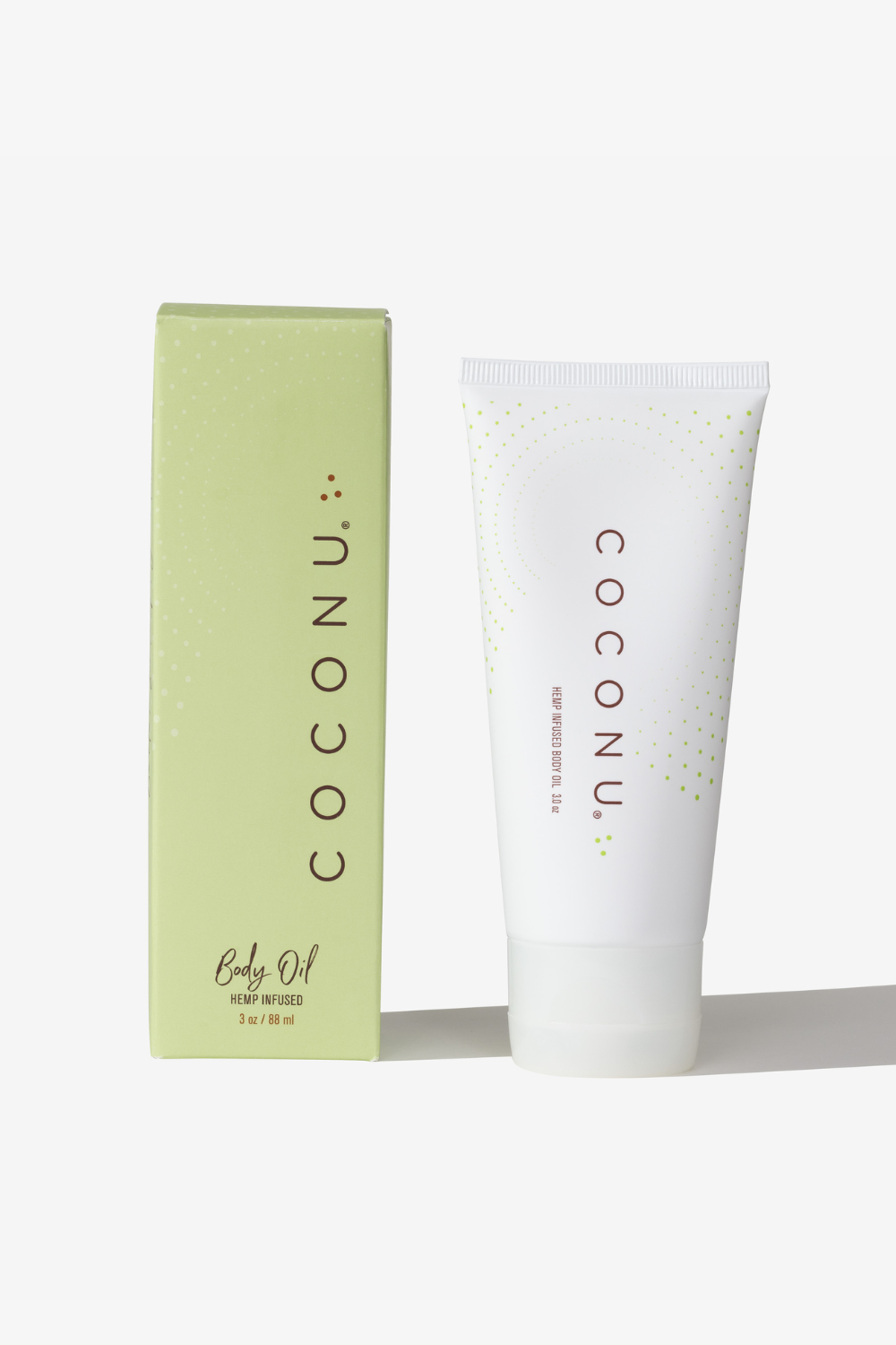 Coconu hemp-infused body oil tube standing beside its green carton