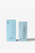 Coconu oil-based singles carton with a single-use sachet standing alongside