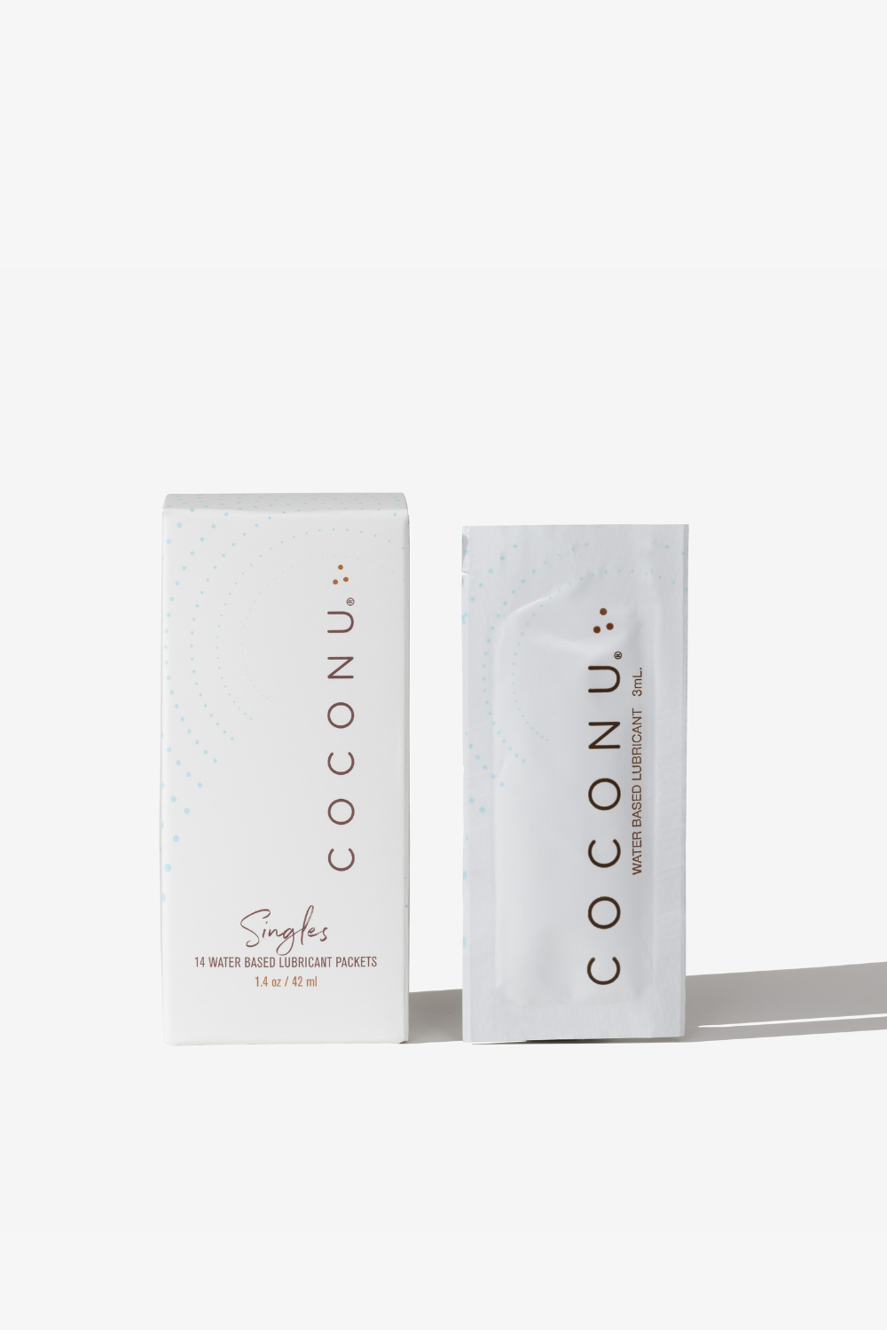 Coconu water-based singles carton with a single-use sachet standing alongside