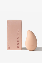 The peach Coconu Wave body massager beside its pink carton