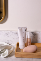 Coconu tube, toy cleaner and Wave massager on a wooden tray in a bathroom