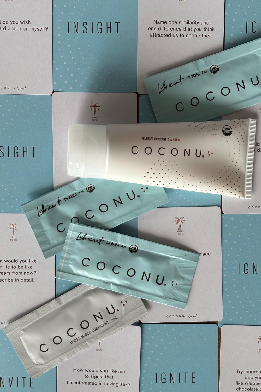 Coconu tube and single sachets laid over Coconu Connect card boxes